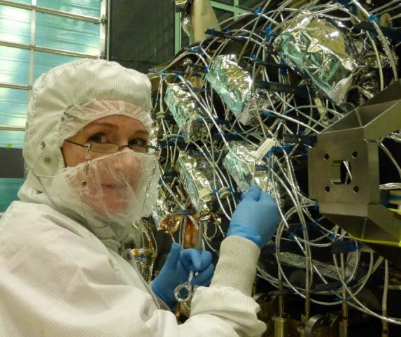 Melanie Ott in cleanroom working on flight optical hardware